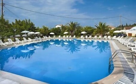 Seasonal outdoor pool, open 9:00 AM to 8:00 PM, sun loungers. Tzilios Studios