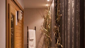 A hallway with wooden paneling, a towel rack, and a potted plant. - MC San José (Nijar)