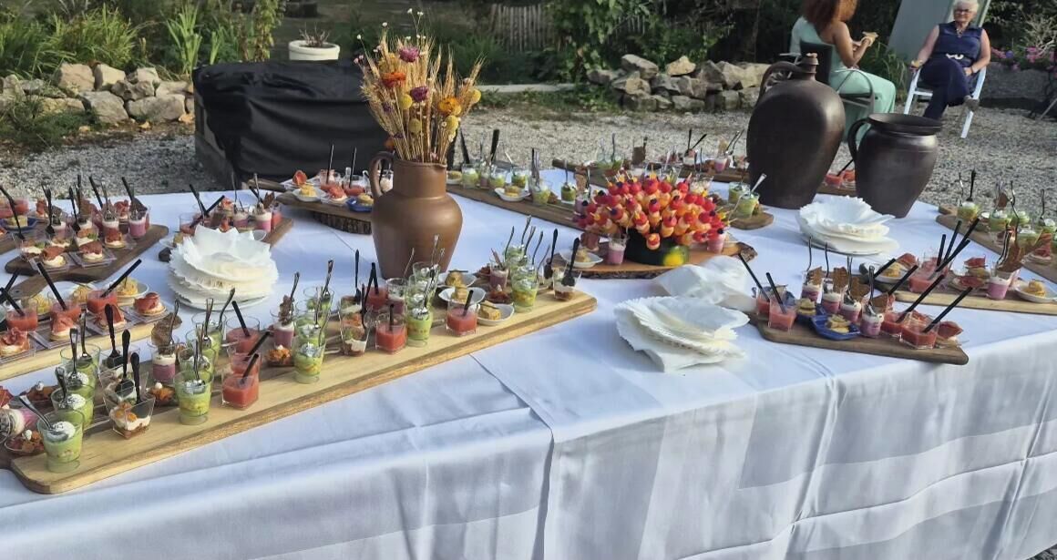 A buffet table with various food items and drinks.