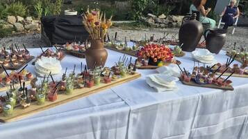 A buffet table with various food items and drinks.