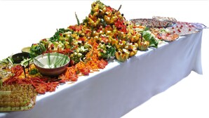 A buffet table with various food items and a bowl of salad. - Hotel Bayle (Belcaire)