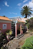 A building with a sign for 'Madera Hotel & Villas' and a covered entrance area with steps leading up to it.