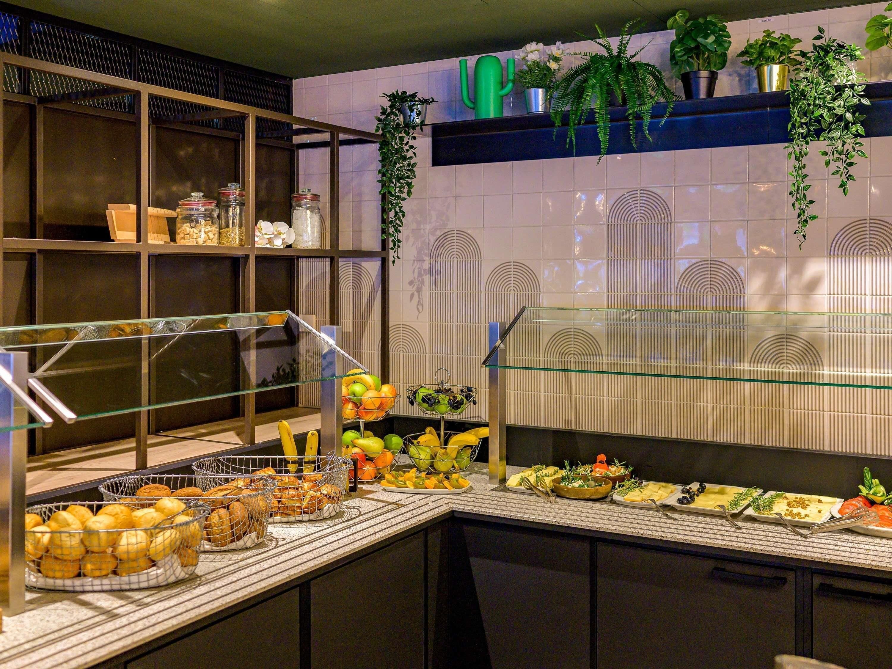 A buffet setup with various food items and a glass display case.