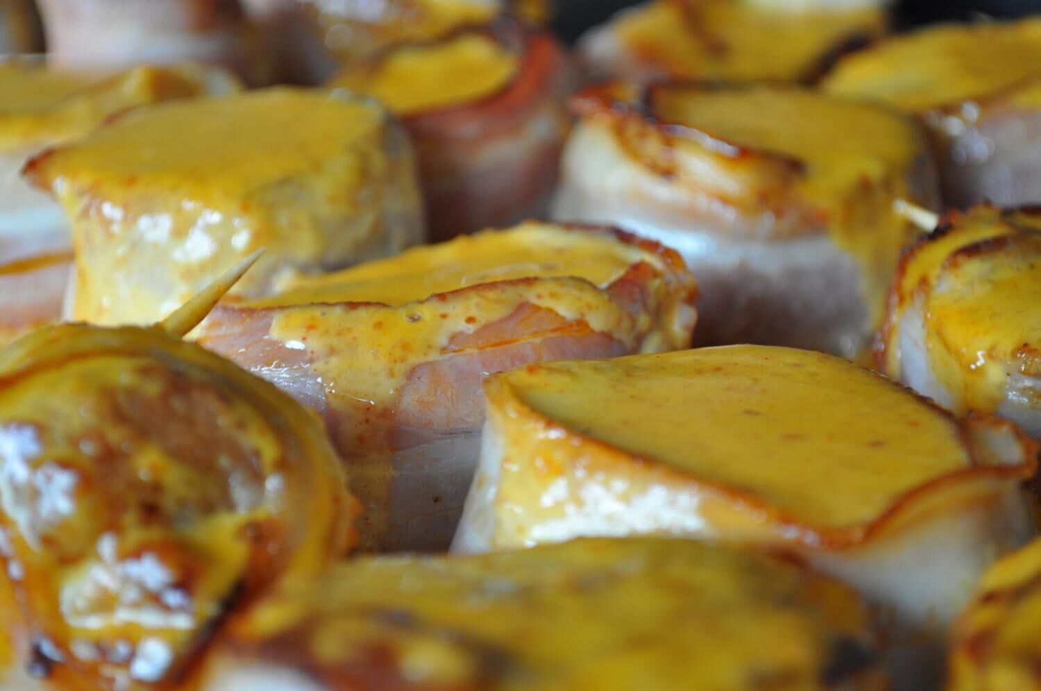 A close-up of food items, likely a dish with a golden-brown crust, possibly a type of baked or grilled food.