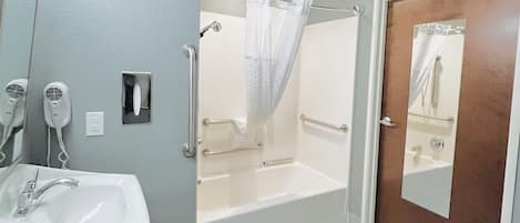 A bathroom with a sink, mirror, hair dryer, and a shower with a glass door.