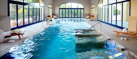 Indoor pool, pool umbrellas, pool loungers