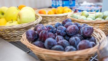 A display of various fruits in wicker baskets.