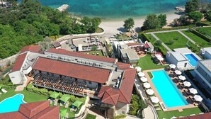 An aerial view of a resort with a swimming pool, beach, and lush greenery. - Blue Waves Resort (Malinska-Dubasnica)