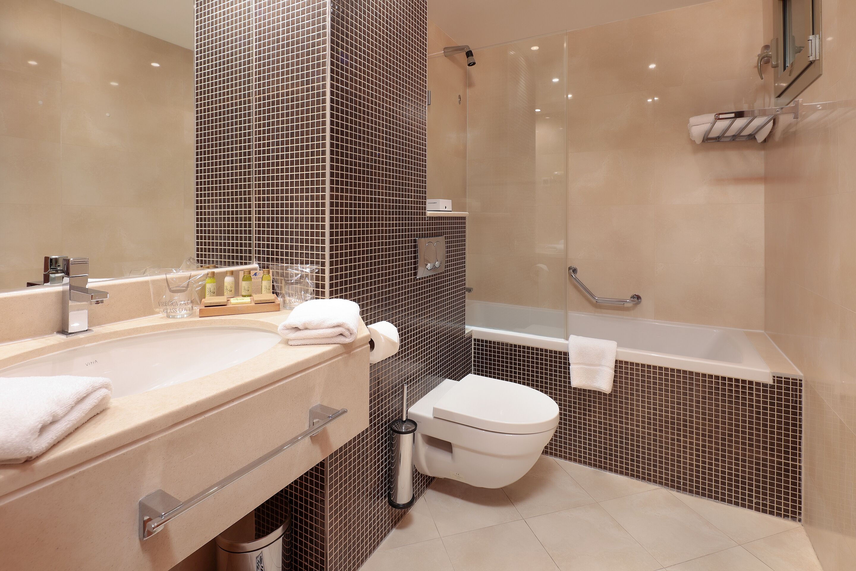 A modern bathroom with a sink, toilet, and shower area.