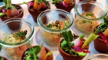 A table with various dishes and small potted plants.