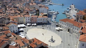 A coastal town with a central square, historic buildings, and a marina.
