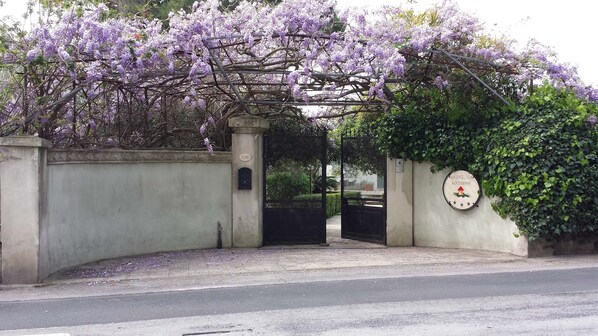 A gated entrance with a sign indicating a location.
