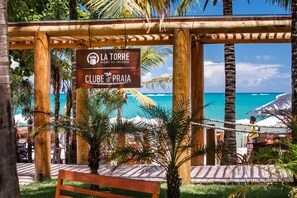 A wooden pergola with a sign for La Torre Resort All Inclusive Club de Praia.