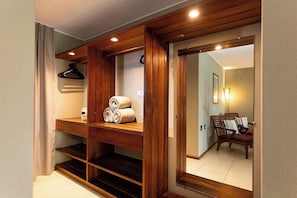 A wooden interior with a sliding door leading to a room with a chair and lamp.