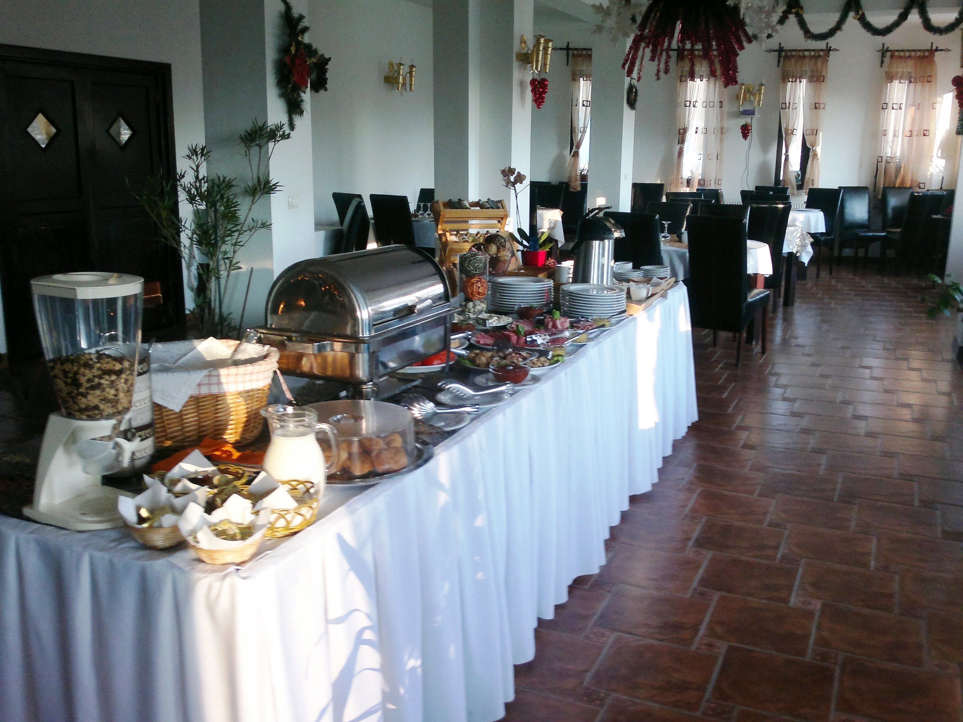 A buffet setup with various food items and a coffee station.