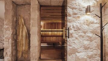 Un muro de piedra con una puerta de madera que dice "FINSE SAUNA 90°".
