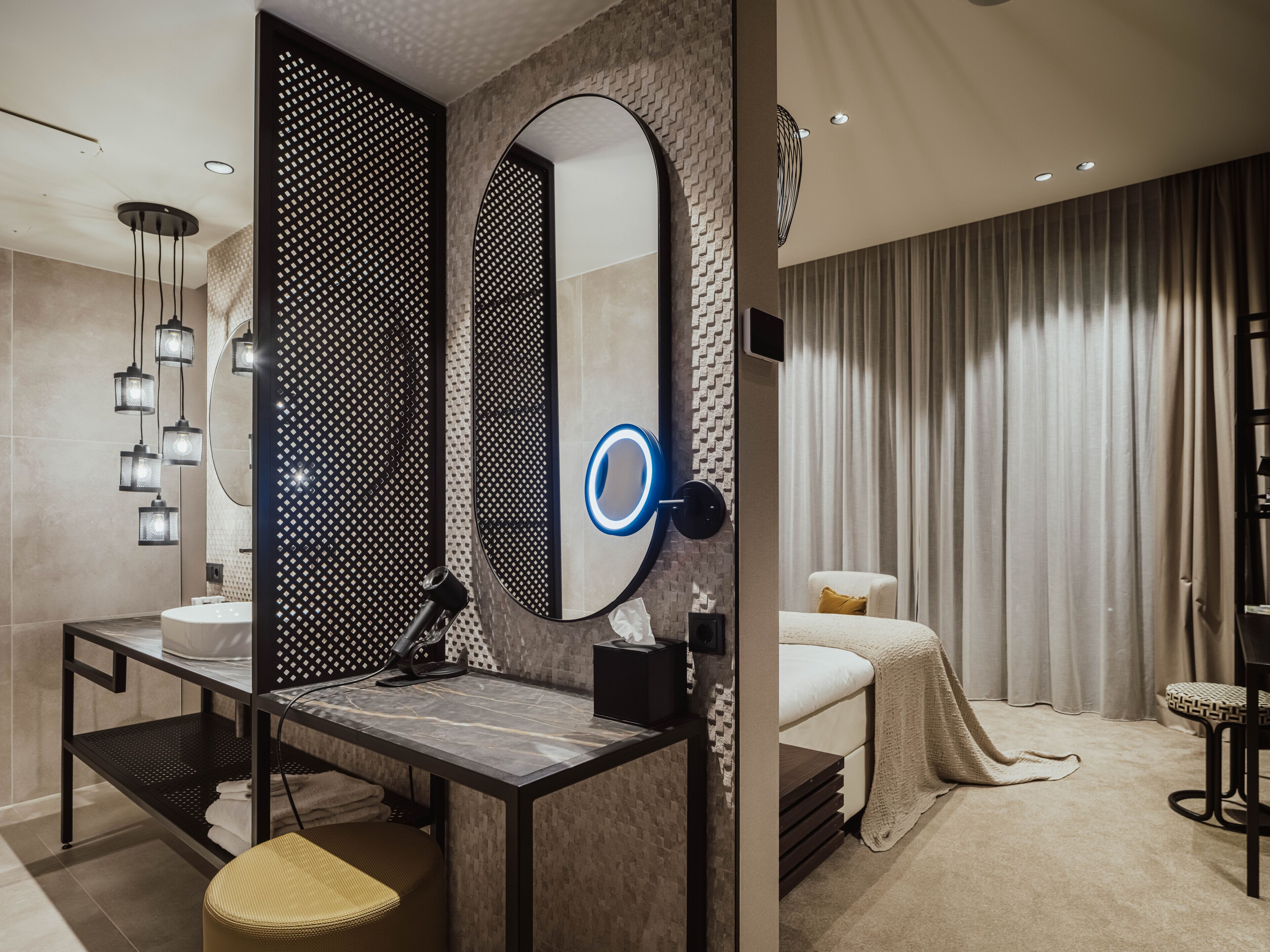 A modern bathroom with a vanity, mirror, and towel rack.