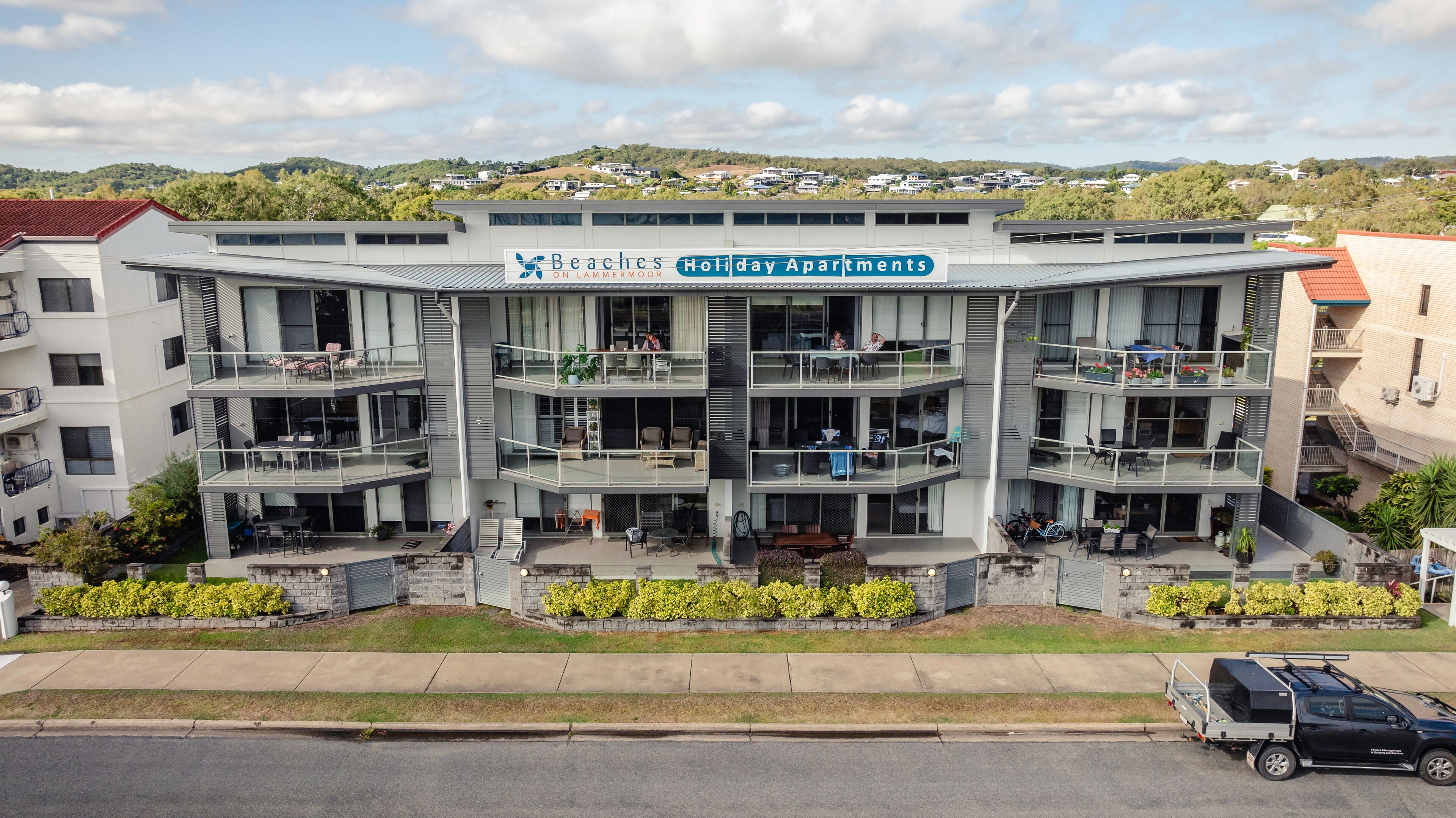 A multi-story building with balconies, labeled as holiday apartments.