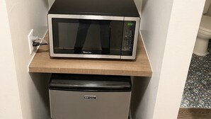 A compact kitchen with a microwave and a mini-fridge. - Dunes Motel Hillsboro (Hillsboro)