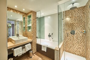 A modern bathroom with two sinks, a glass-enclosed shower, and a large mirror. - Crowne Plaza Reading by IHG (Reading)