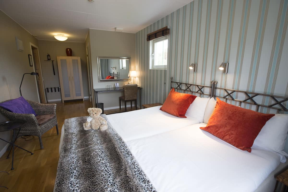 standard double room | pillow-top beds, desk, blackout curtains, rollaway beds