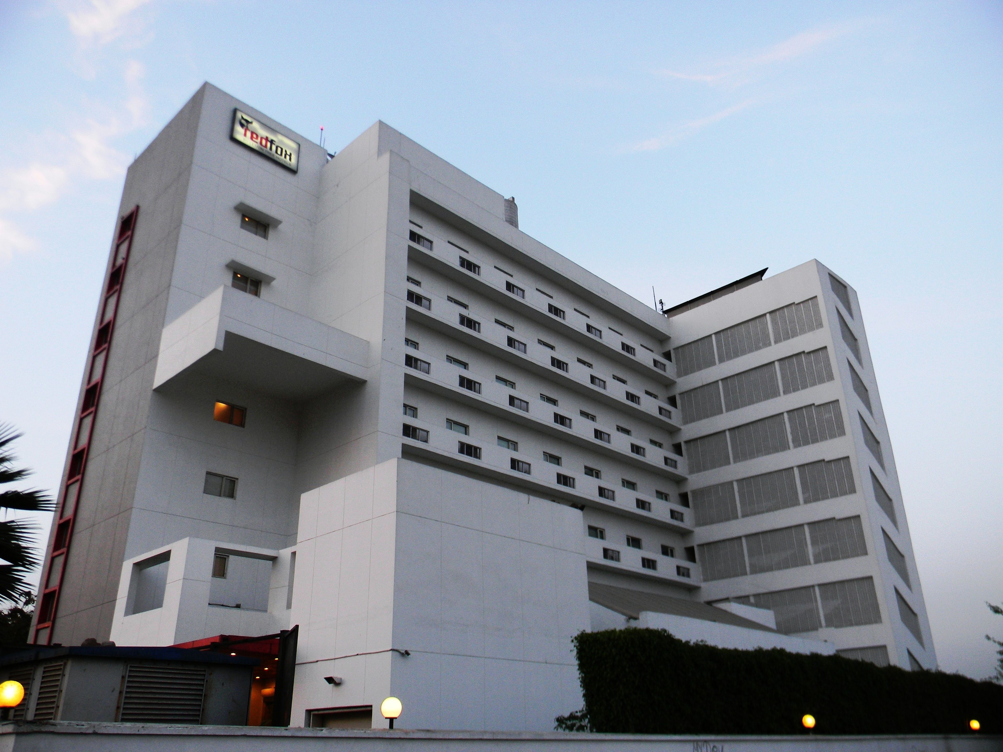 A multi-story hotel with a modern design, featuring a prominent entrance and multiple balconies.