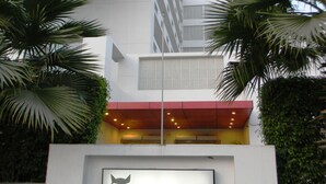 A modern building with a sign for 'Redfox by Lemon Tree Hotels'.