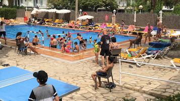 Seasonal outdoor pool, open 10:00 AM to 7:00 PM, pool umbrellas