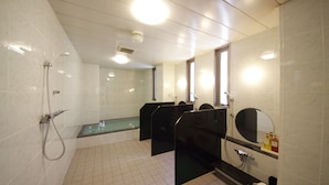 A modern bathroom with a glass partition, a shower area, and a mirror. - Urbain Hiroshima Executive (Hiroshima)