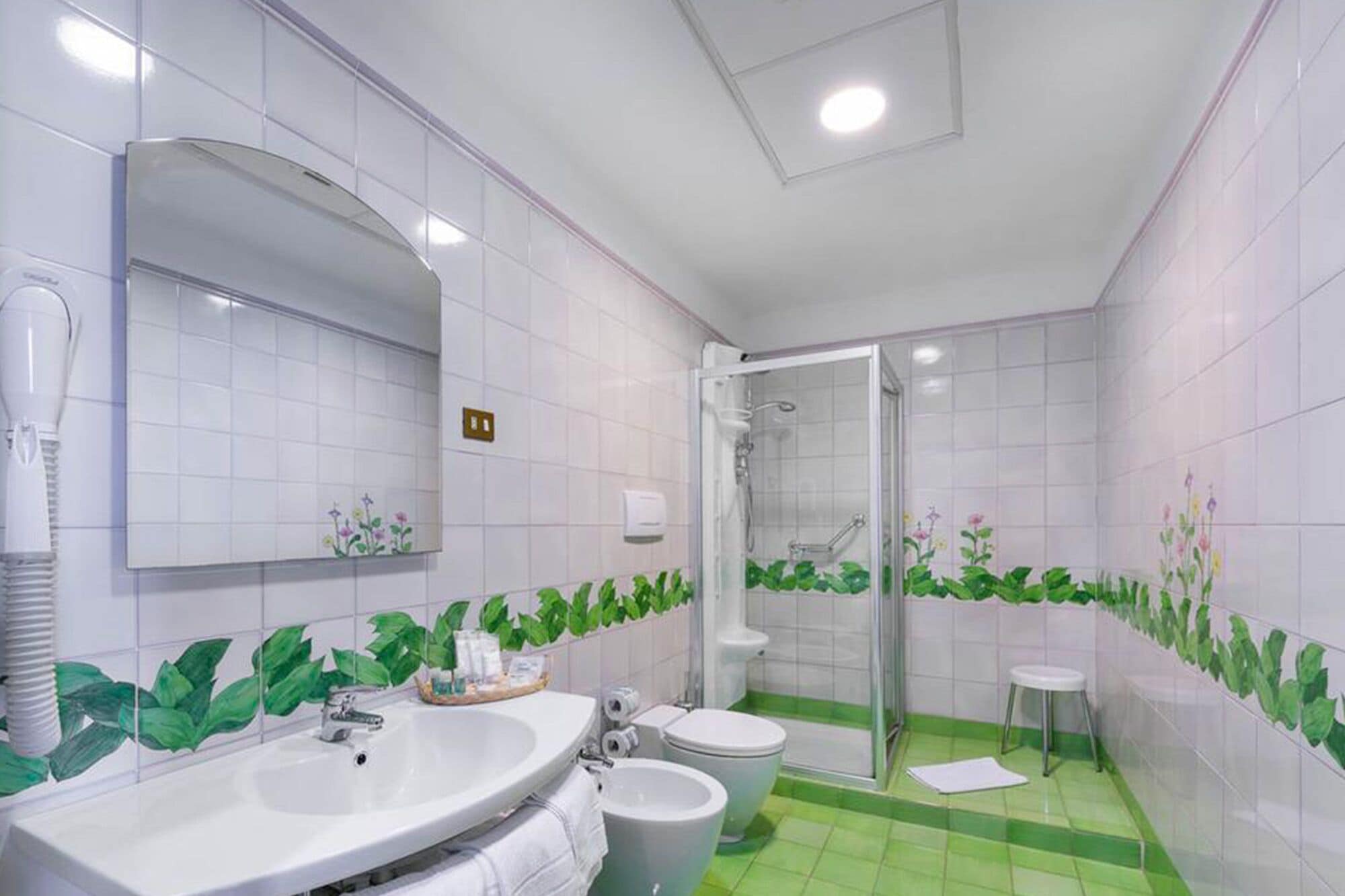 A bathroom with a sink, toilet, and shower.
