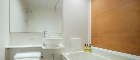 Une salle de bain avec une baignoire blanche, un lavabo et un miroir.