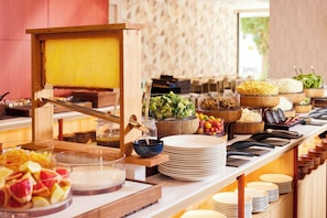 A buffet setup with various food items and a honey dipper. - Hotel MyStays Nagoya - Sakae (Nagoya)