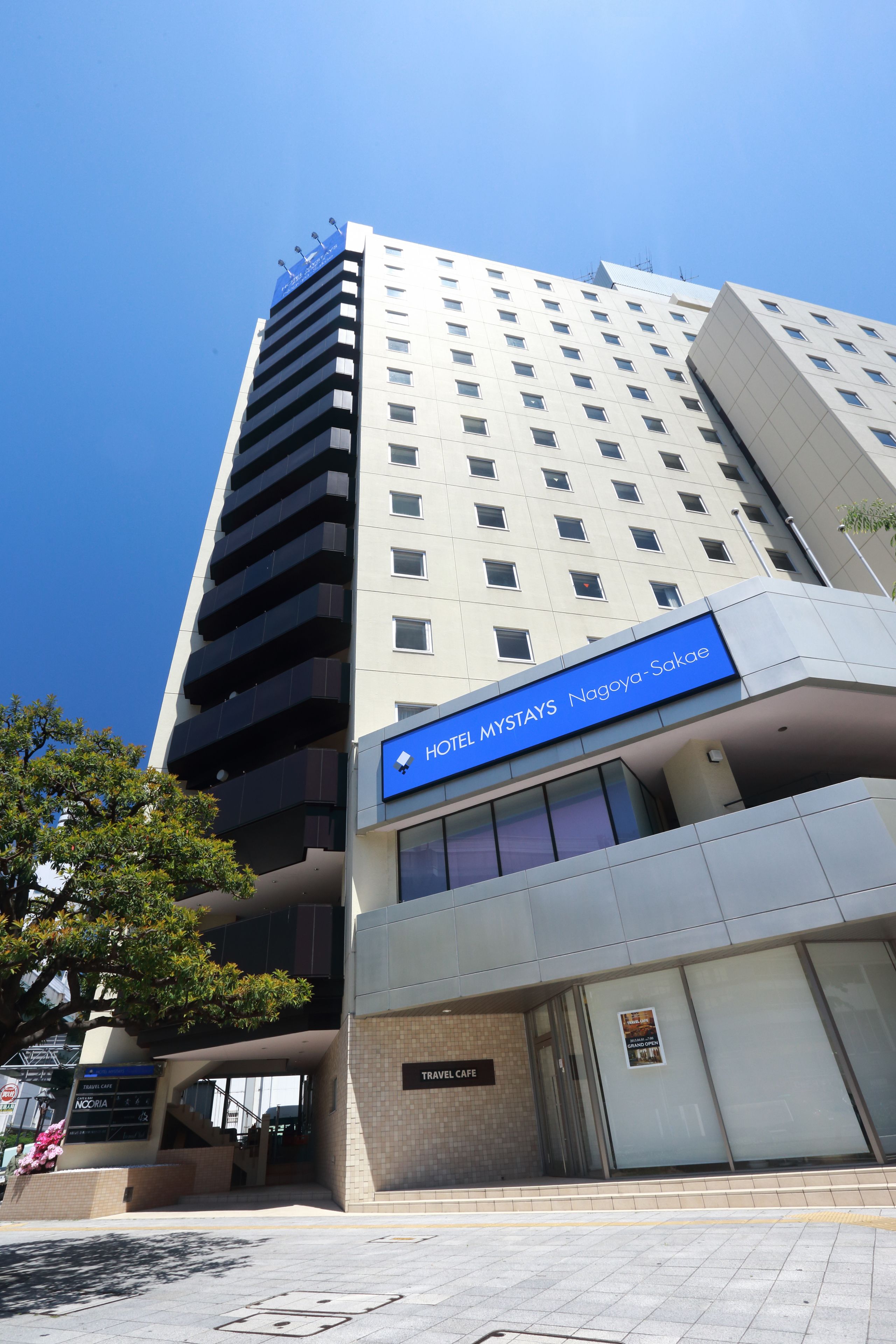 A modern hotel with a prominent sign for Hotel Mystays Nagoya-Sakai.