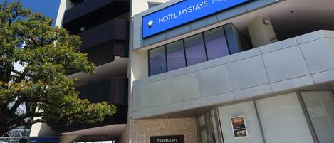 A modern hotel with a prominent sign for Hotel Mystays Nagoya-Sakai.