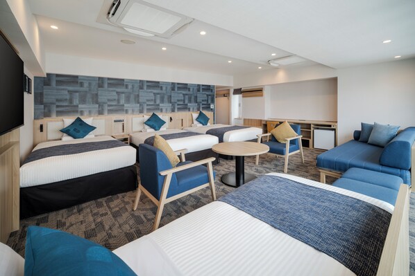 A modern hotel room with a large bed, two smaller beds, a sofa, a dining table, and a TV. - Hotel MyStays Nagoya - Sakae (Nagoya)