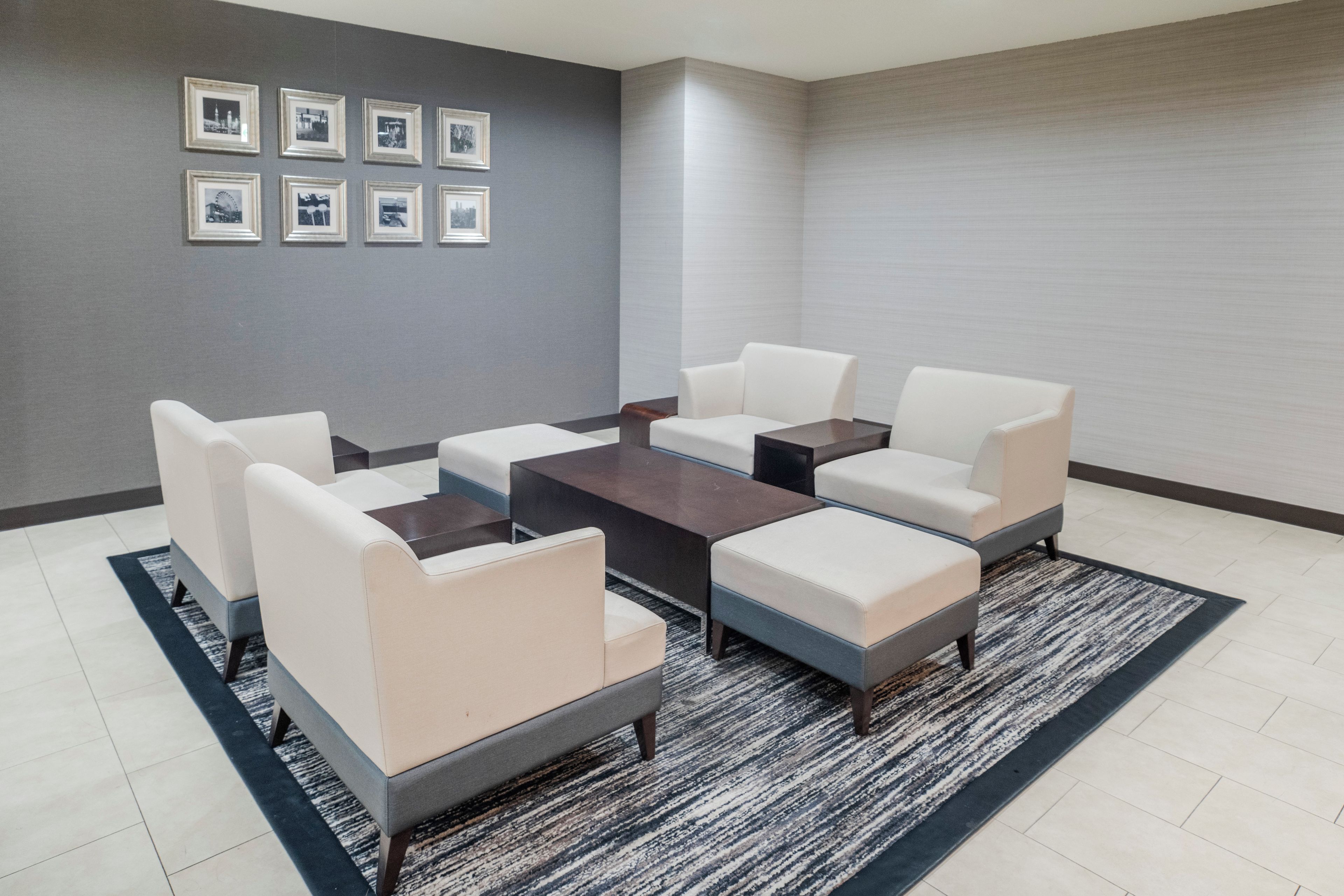 A modern lounge area with a sofa set, a coffee table, and a rug.