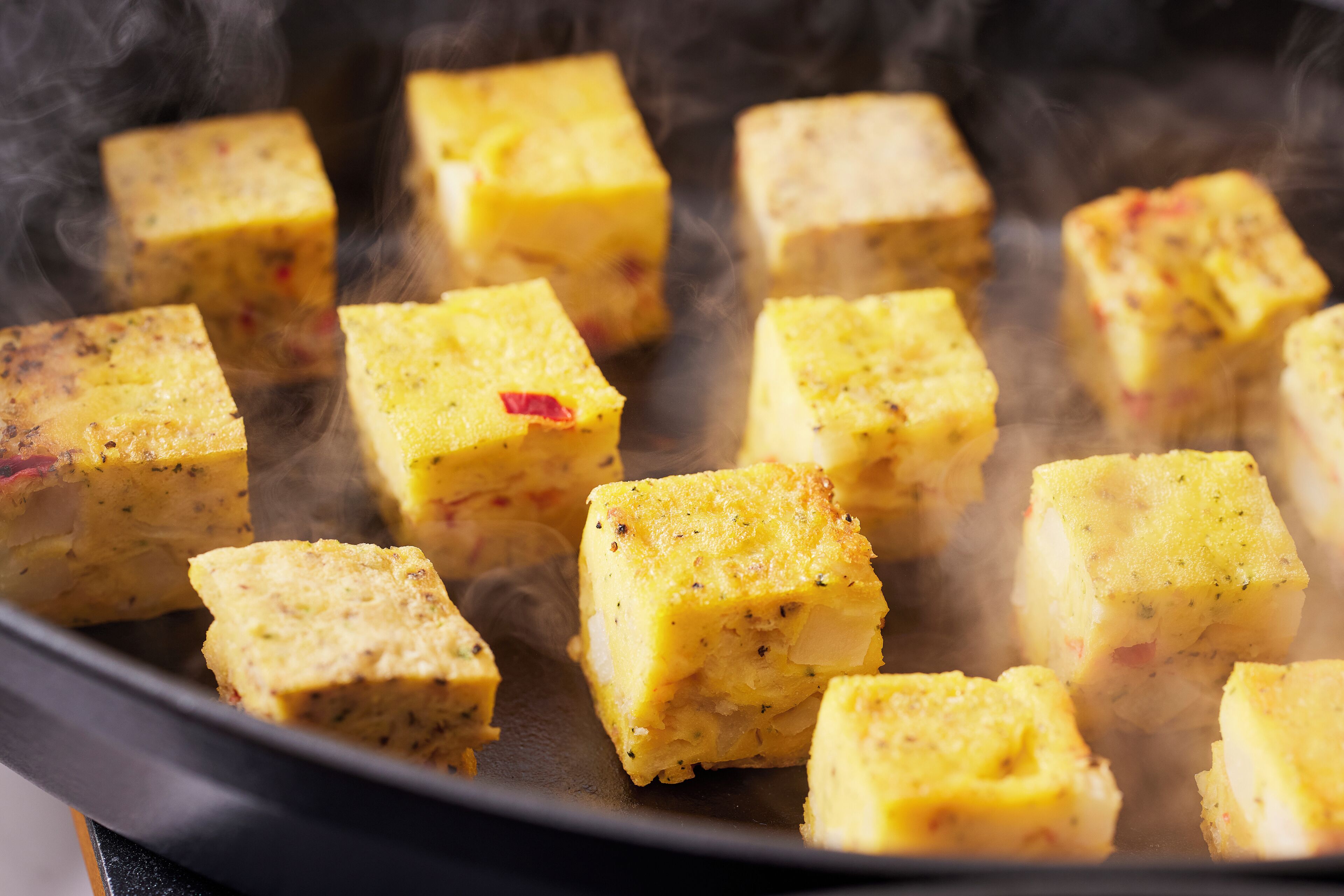A close-up of food items being cooked in a pan.