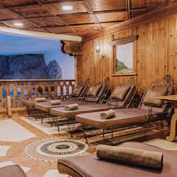 Relax in a cozy seating area with lounge chairs and a stunning mountain mural.