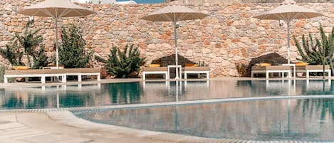 Outdoor pool, open 9:00 AM to 8:00 PM, pool umbrellas, pool loungers