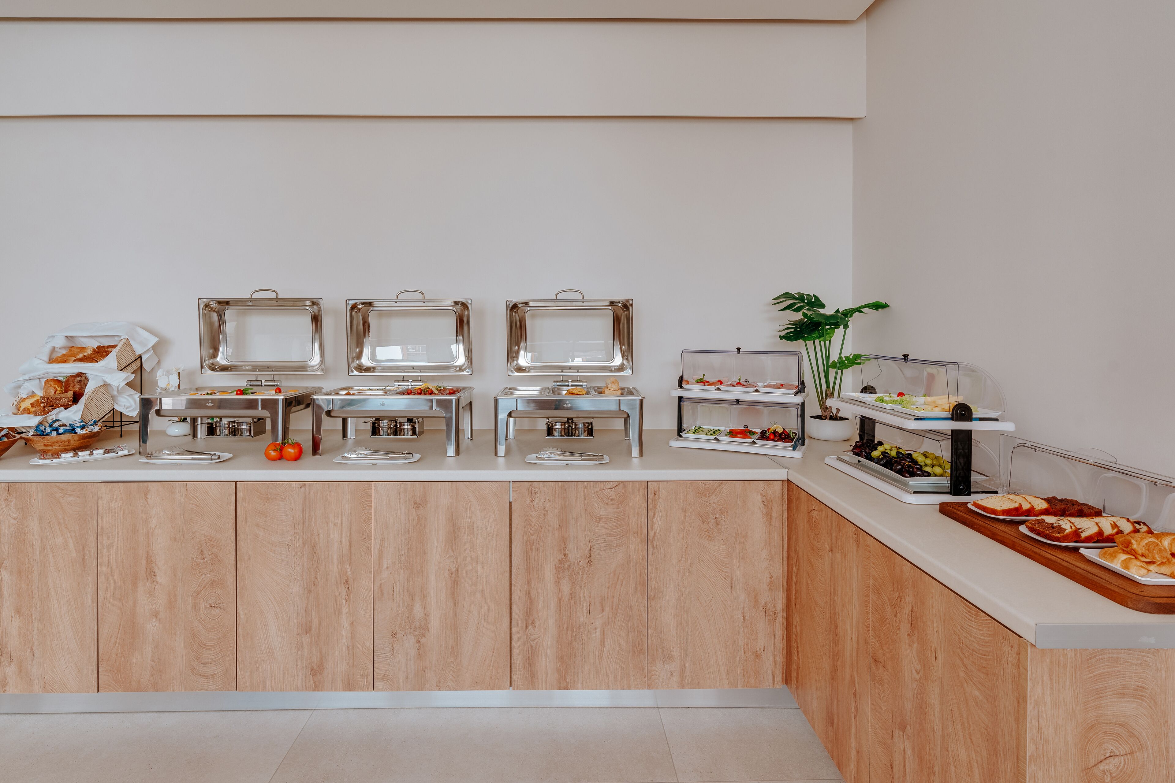 A buffet setup with various food items and containers.