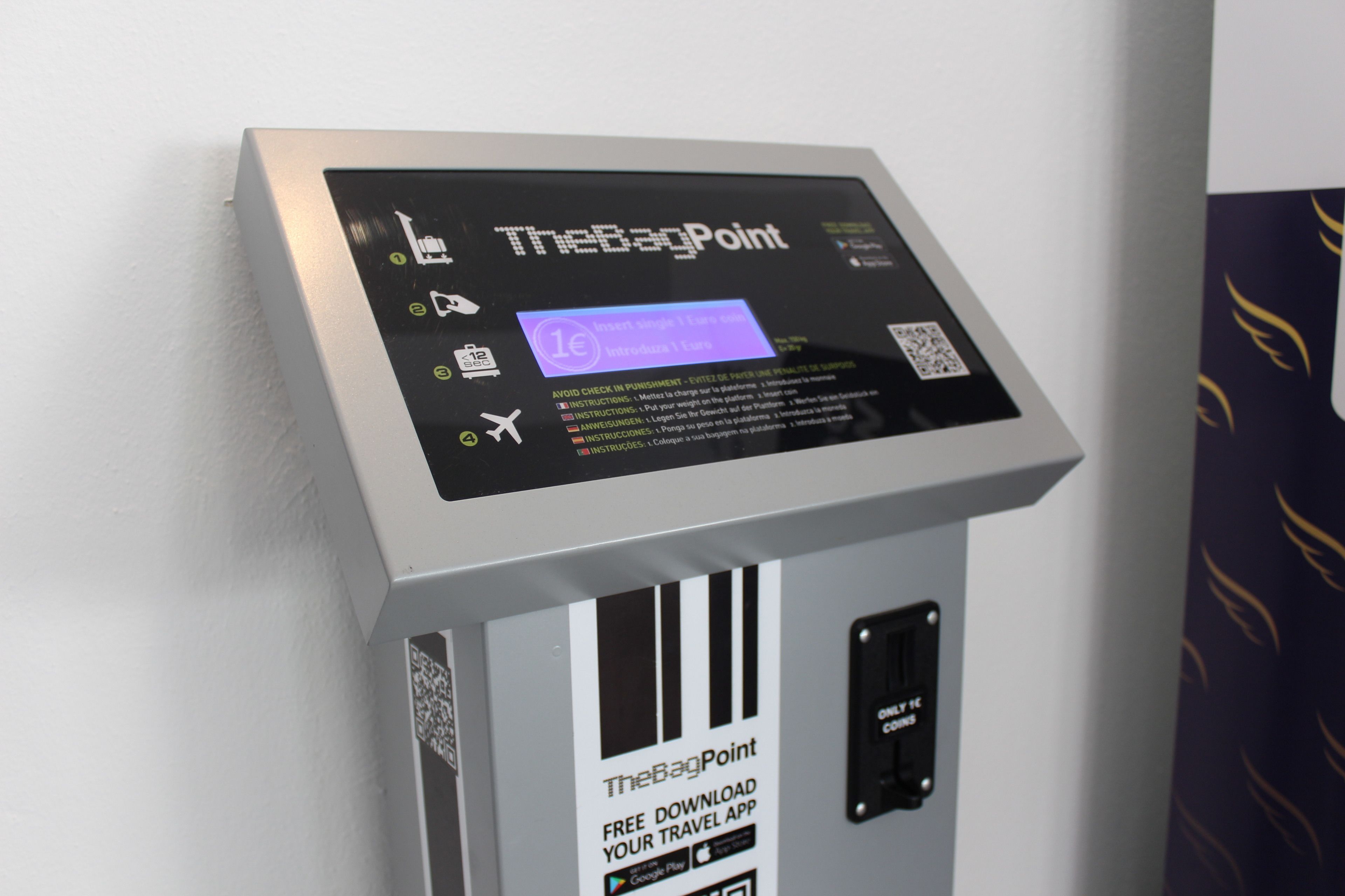 A TheBagPoint kiosk with a screen displaying travel app information.