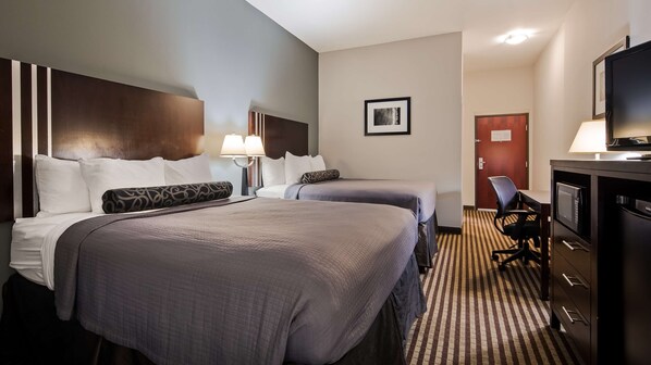A hotel room with two beds, a desk with a computer, a TV, and a microwave. - Best Western Abbeville Inn & Suites (Abbeville)