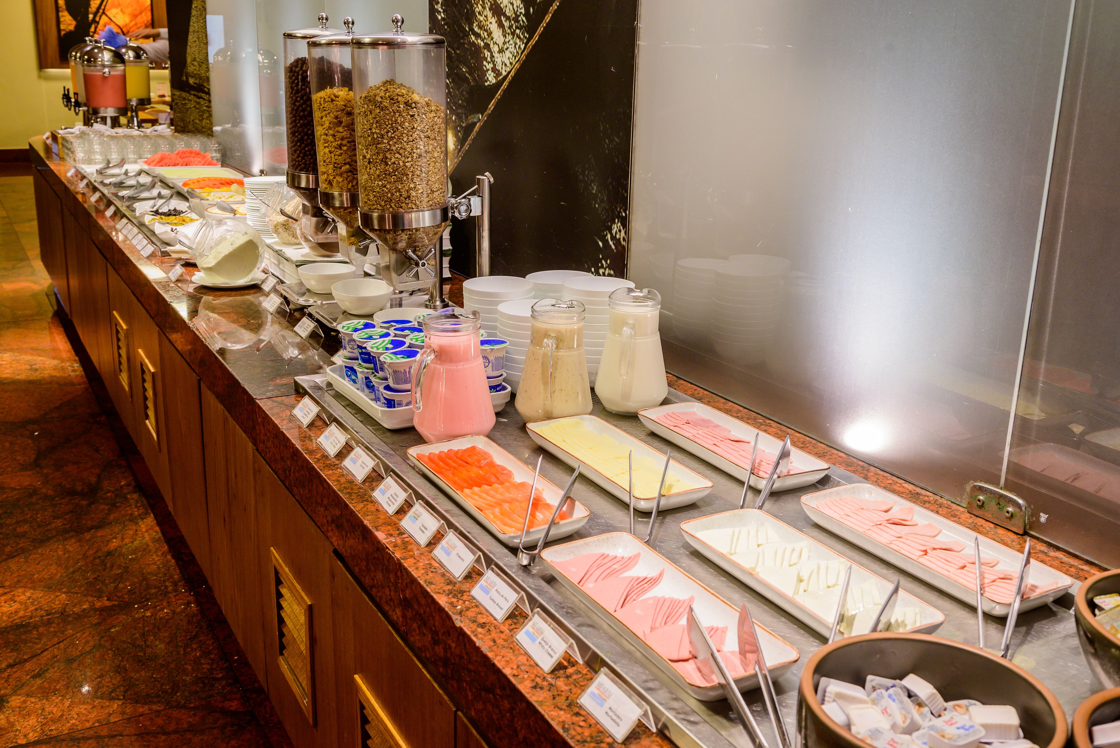 A buffet with various food items and beverages.