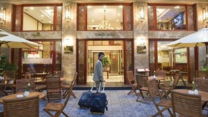 A hotel lobby with a central seating area, a reception desk, and a visible restaurant and bar area. - Conifer Boutique Hotel (Hanoi)