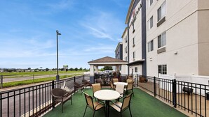 A hotel patio with a gazebo, outdoor seating, and a view of the road. - Candlewood Suites Cape Girardeau by IHG (Cape Girardeau)