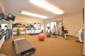 A gym with cardio equipment, weight machines, and a water dispenser. - Candlewood Suites Cape Girardeau by IHG (Cape Girardeau)