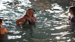 A swimming pool with clear water and visible pool lane markings. - River Valley Inn & Suites (Osceola)