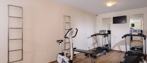 A gym with treadmills, an elliptical, and a stair climber.