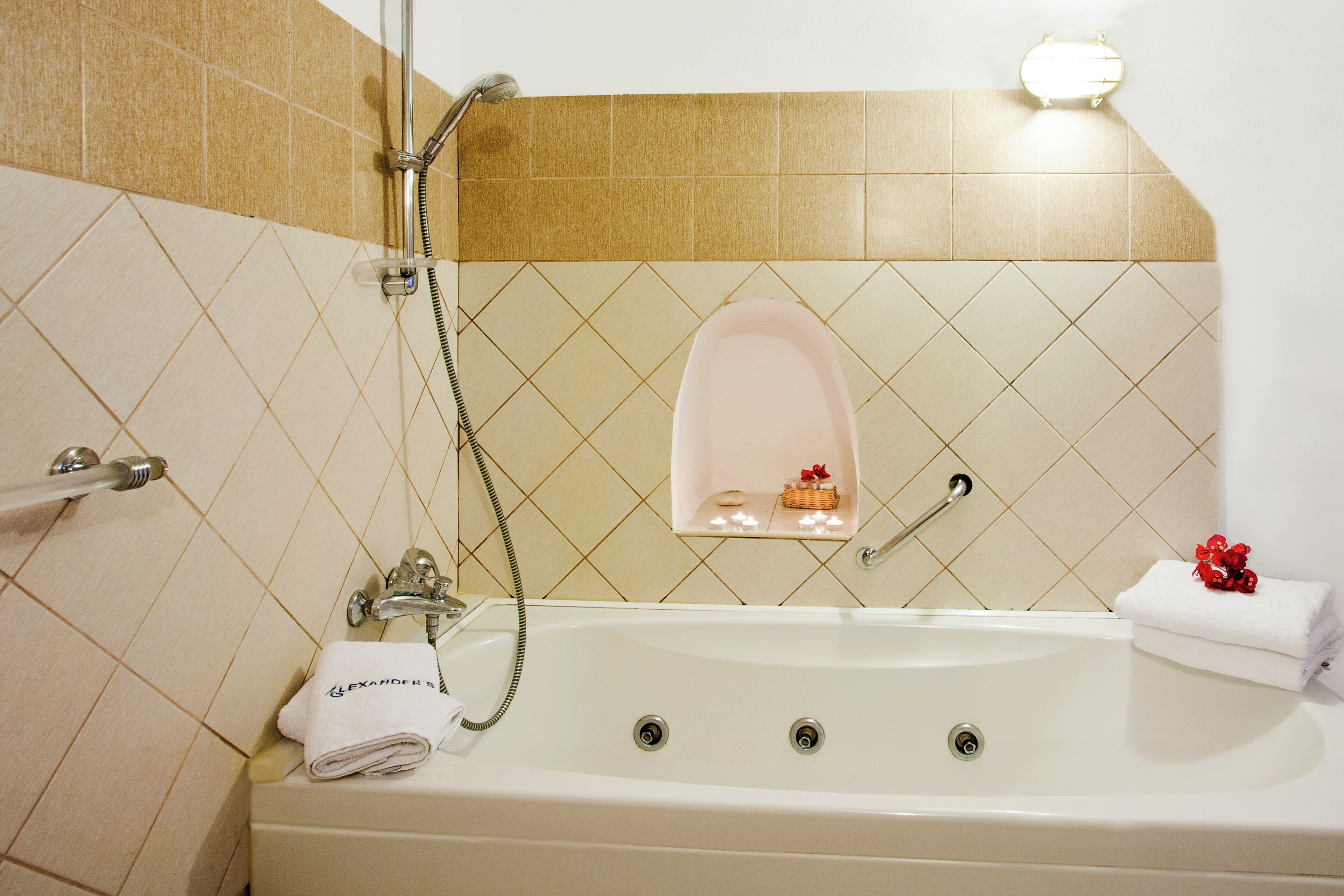 A bathroom with a bathtub, a shower, and a towel rack.