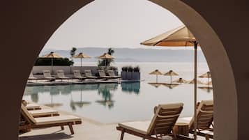 Seasonal outdoor pool, open 10:00 AM to 6:00 PM, pool umbrellas